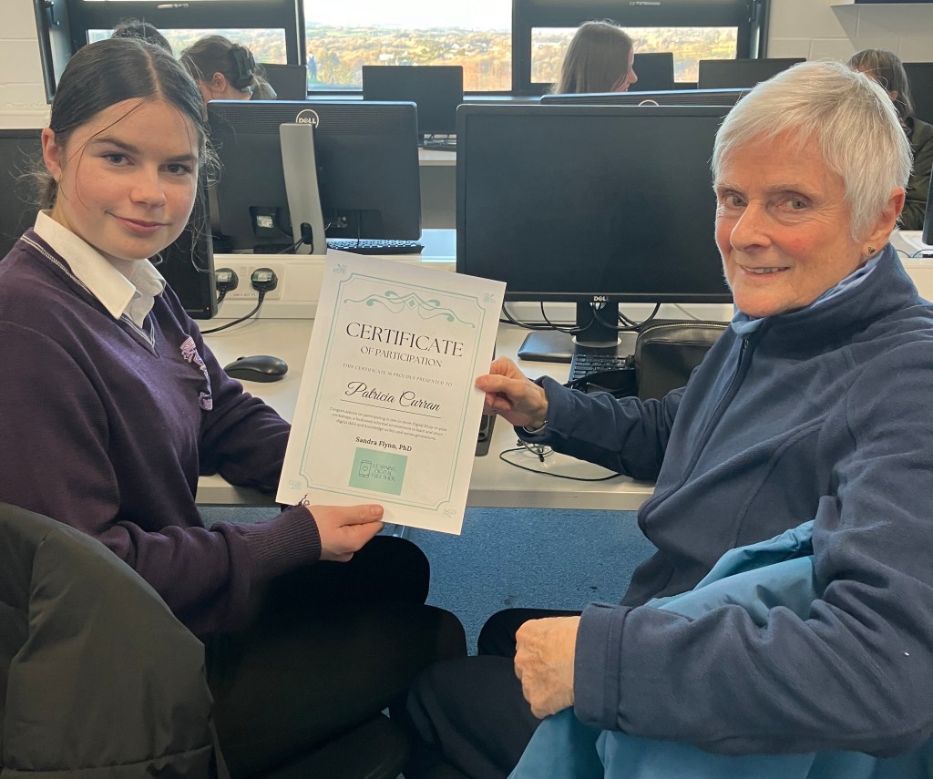 Student presenting a certificate to learner