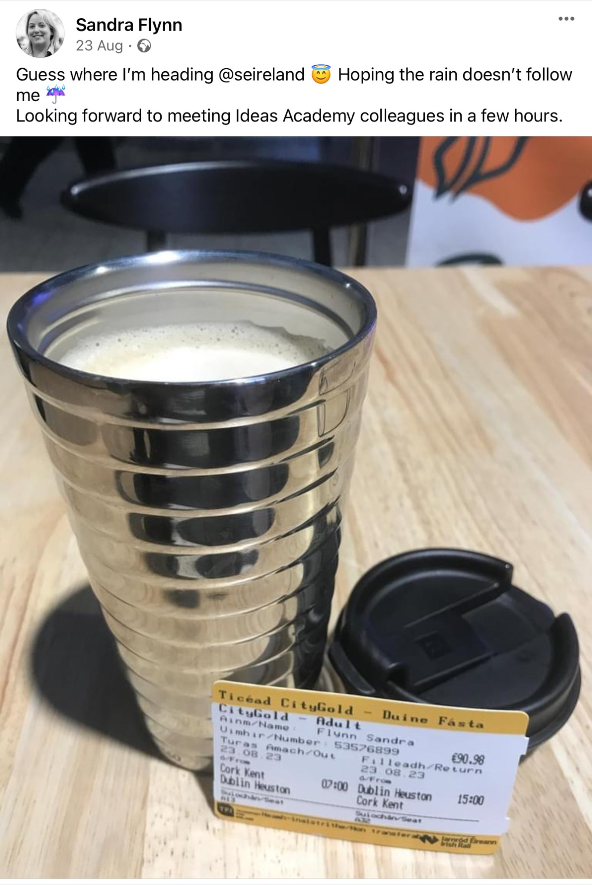 Photo of a reusable coffee cup and a train ticket with text from a Facebook post.